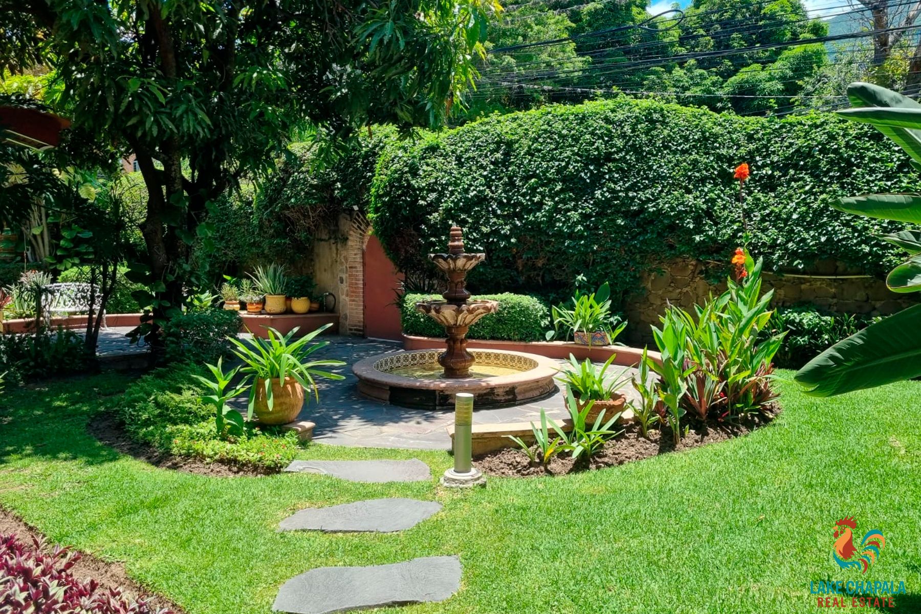 01 Lush Front Garden with Cantera Stone Fountain and Flagstone Terrace
