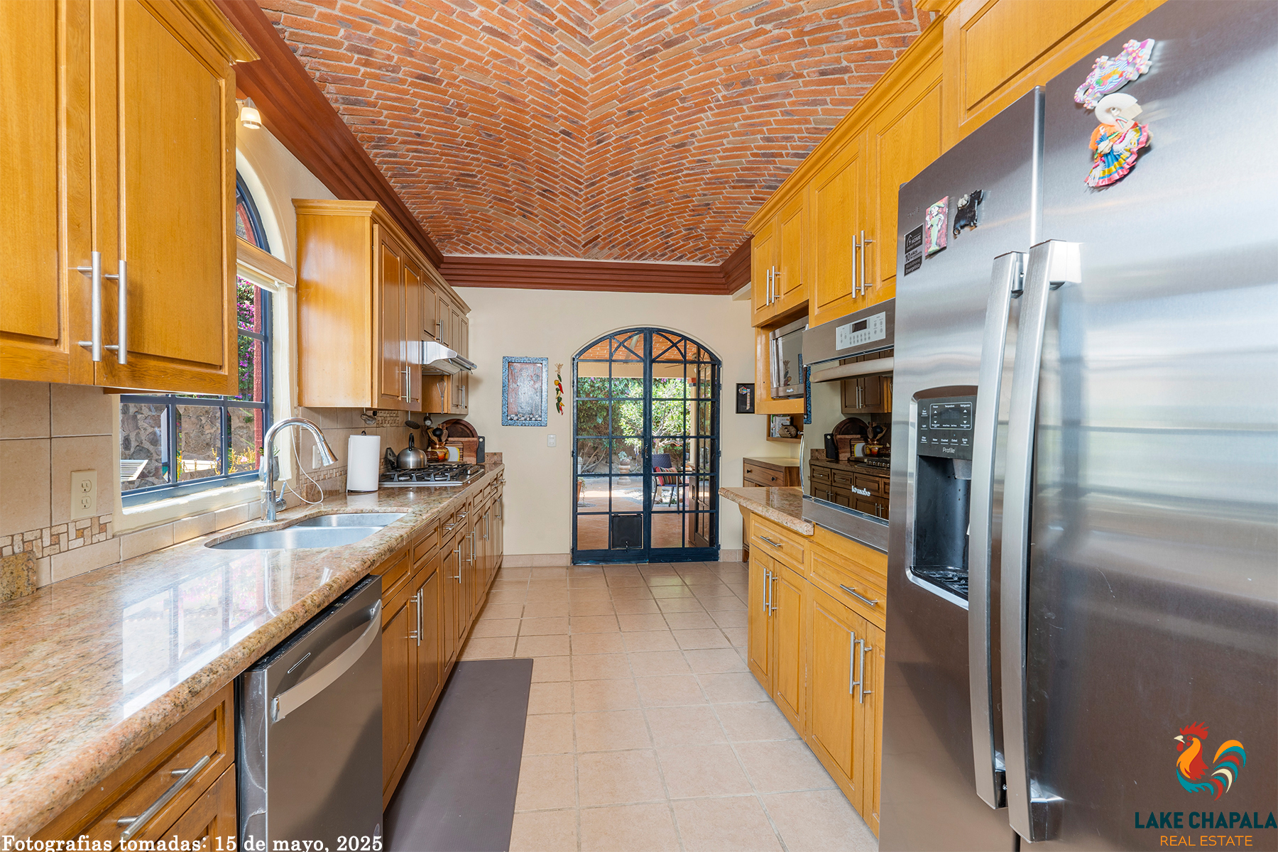 03 Spacious Kitchen with Brick Domed Ceiling Leads Out to Grilling Kitchen and Garden Terrace